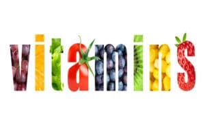A white background with the word vitamin written in different fruits.
